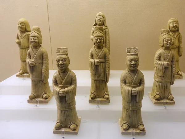 Tang-dynasty pottery figures showing varied garments and hairstyles