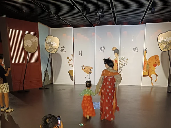 Visitors viewing Tang-style clothing at a museum exhibition