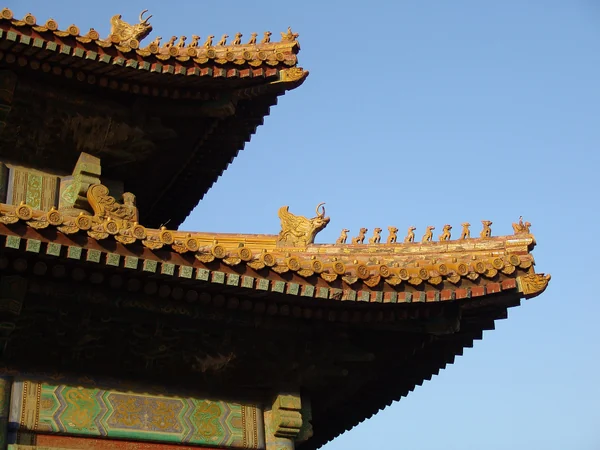 Yellow glazed roof tiles above red walls in the Forbidden City Yellow glazed roof tiles above red walls in the Forbidden City
