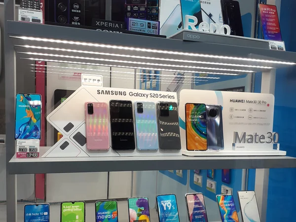 Smartphones displayed in a China Mobile shop window in Hong Kong