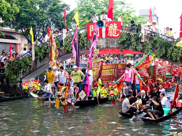 Paddlers competing in a dragon boat race during a community festival