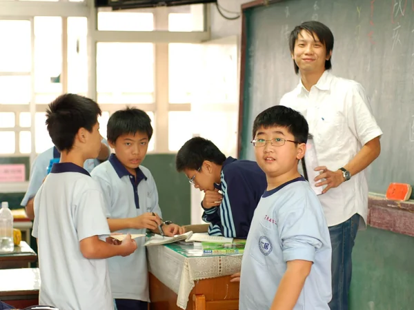 A teacher and students in a Chinese-language classroom