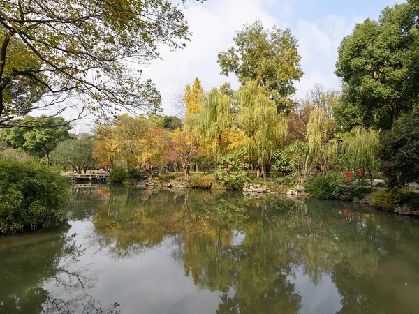 Visitors moving through the layered architecture of a classical Suzhou garden