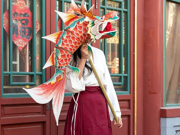 A woman holding a handmade dragon lantern at Changdian Temple Fair
