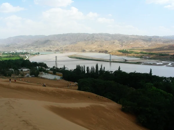Sand dunes meeting the Yellow River landscape at Shapotou in Zhongwei