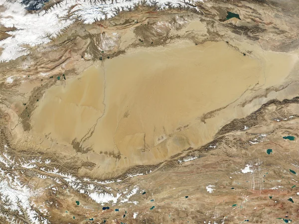 Layered dunes stretching across the Taklimakan Desert in Xinjiang