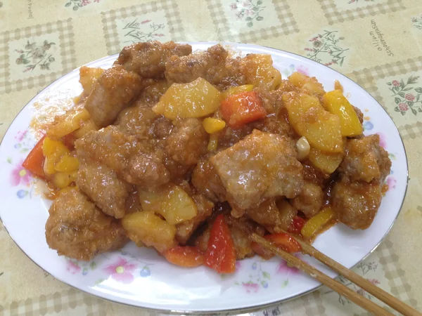 Sweet-and-sour pork ribs coated in a glossy sauce Sweet-and-sour pork ribs coated in a glossy sauce