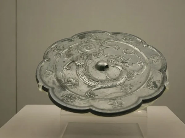 A bronze mirror decorated with a Chinese dragon motif