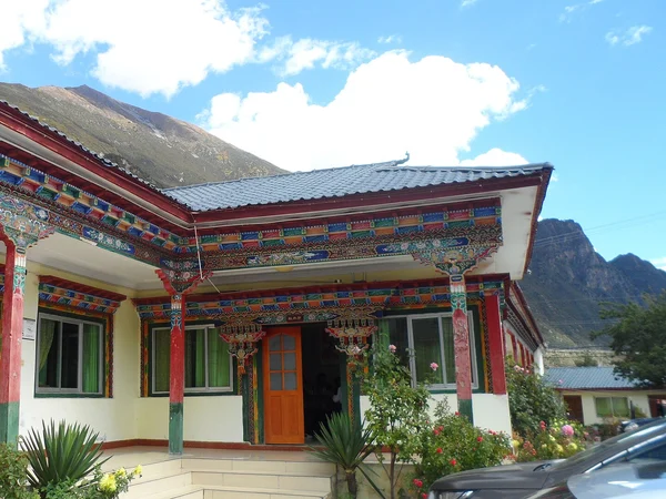 Timber-framed Tibetan house with pitched roof in eastern Tibet