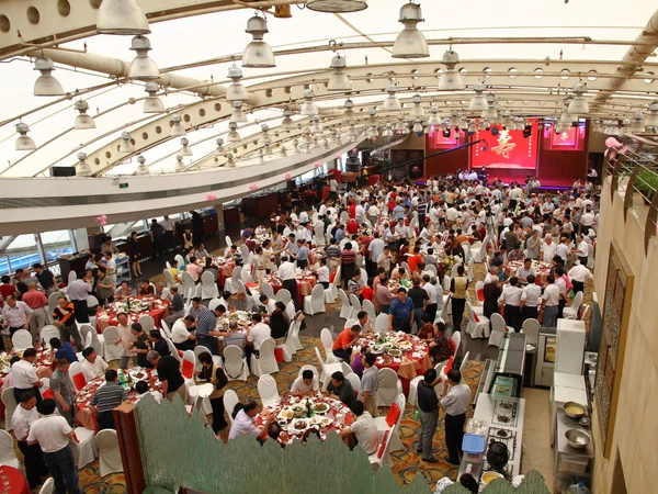 Guests gathered around a Chinese banquet table