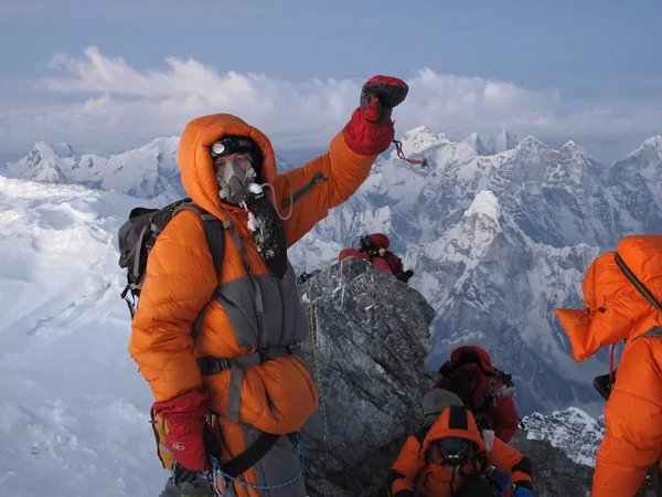 Climbers moving along the upper ridge of Everest at extreme altitude