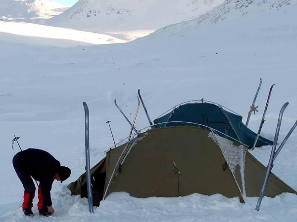 Mountaineer practicing cold-weather camp skills in winter conditions Mountaineer practicing cold-weather camp skills in winter conditions