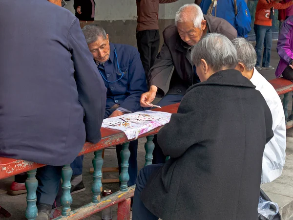 Older residents taking part in a social activity at a public park in China Older residents taking part in a social activity at a public park in China