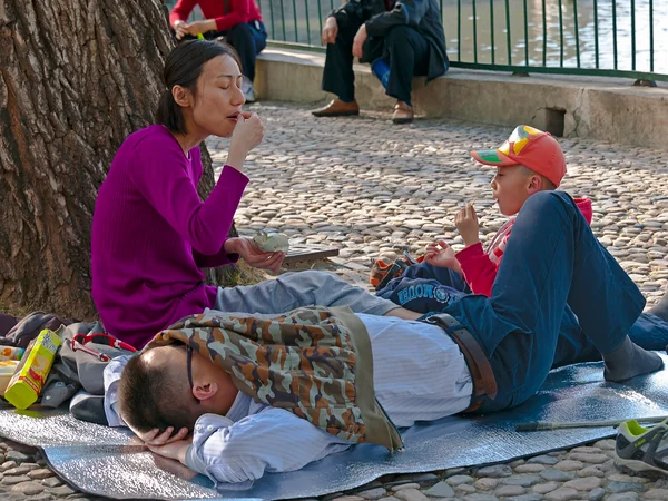 A family with one child visiting Beihai Park in Beijing A family with one child visiting Beihai Park in Beijing