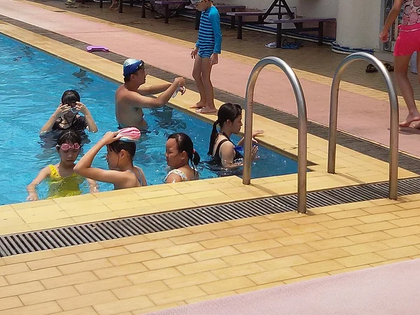 A swimming pool beside the Pearl River, where depth, access rules and close adult attention still matter