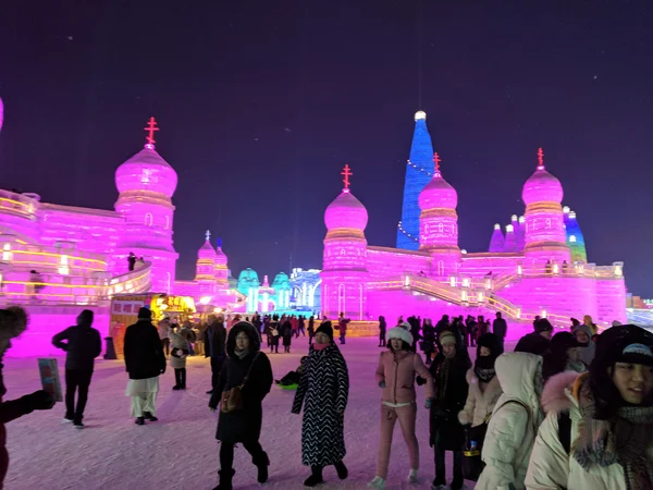 Visitors at Harbin’s illuminated ice festival dressed for severe winter cold