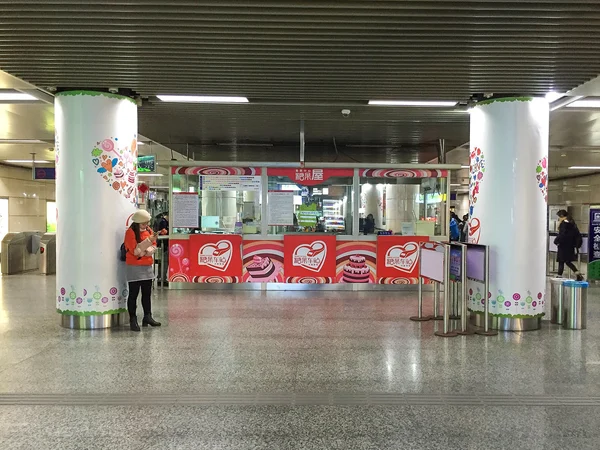 Travellers at a Chinese railway station, illustrating the value of planning transfers around children