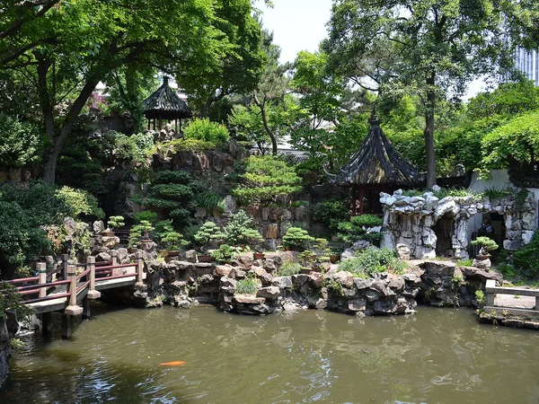Visitors exploring a traditional garden in Shanghai at a slower family pace