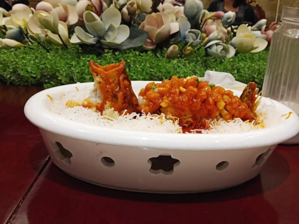 A family-style fish dish in Chongqing, illustrating why ingredients and spice level should be checked before children eat