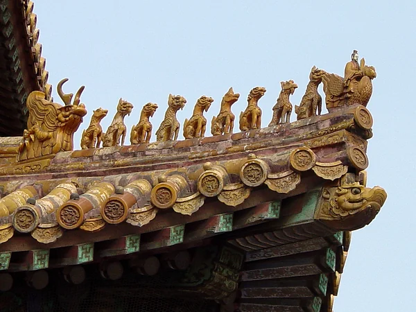 Dragon and guardian figures along a glazed roof in the Forbidden City