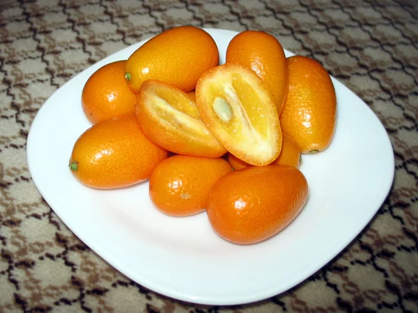 Fresh kumquats arranged on a plate Fresh kumquats arranged on a plate