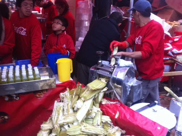 A street vendor pressing fresh sugarcane juice A street vendor pressing fresh sugarcane juice