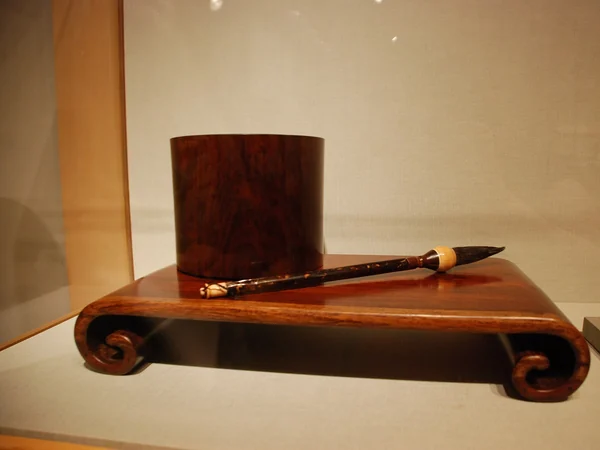 Late Ming or early Qing huanghuali scrolled stand displayed in a museum Late Ming or early Qing huanghuali scrolled stand displayed in a museum