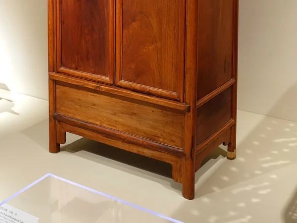 One of a pair of Qing dynasty huanghuali cabinets displayed in a museum