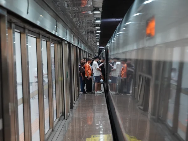 Passengers boarding a high-speed train at Futian Railway Station in China