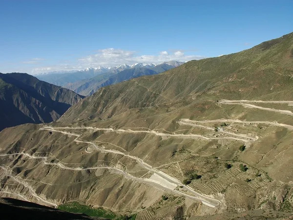 Sichuan Tibet Highway crossing a steep mountain valley Sichuan Tibet Highway crossing a steep mountain valley