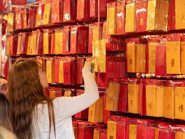 Girls selecting red envelopes for Chinese New Year in Singapore Girls selecting red envelopes for Chinese New Year in Singapore