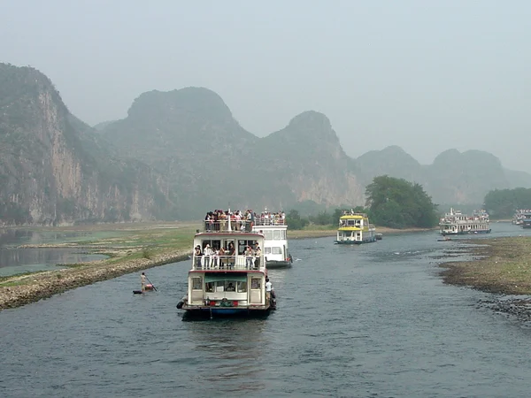 Sightseeing boats traveling through the Guilin karst landscape