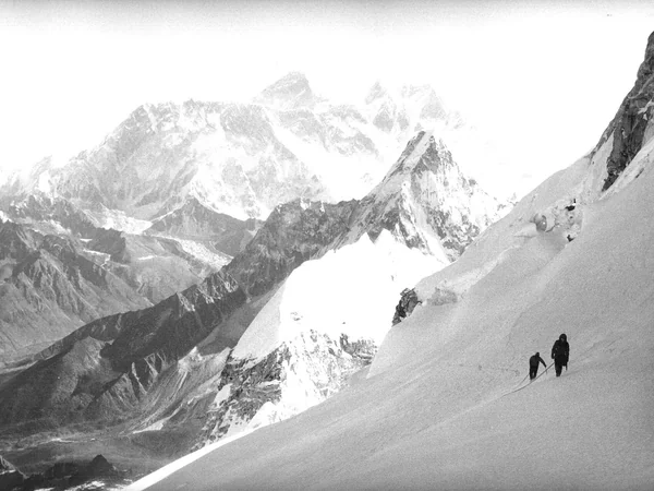 Real climbers ascending a technical high-altitude Himalayan ridge