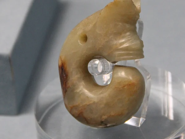 Coiled Hongshan culture jade commonly described as a pig-dragon