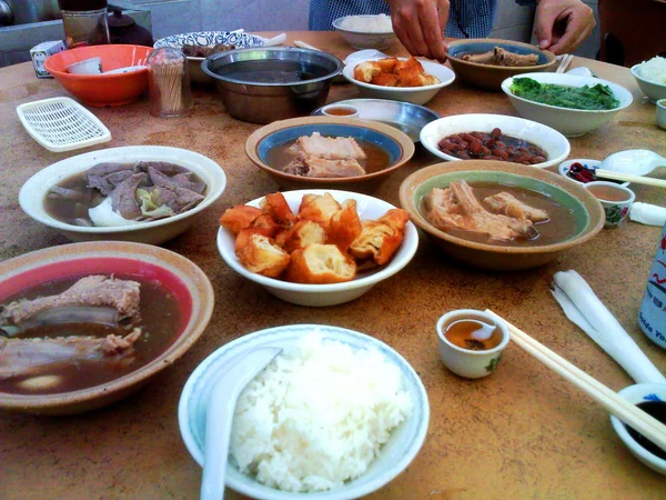 Modern table of regional Chinese dishes prepared for sharing