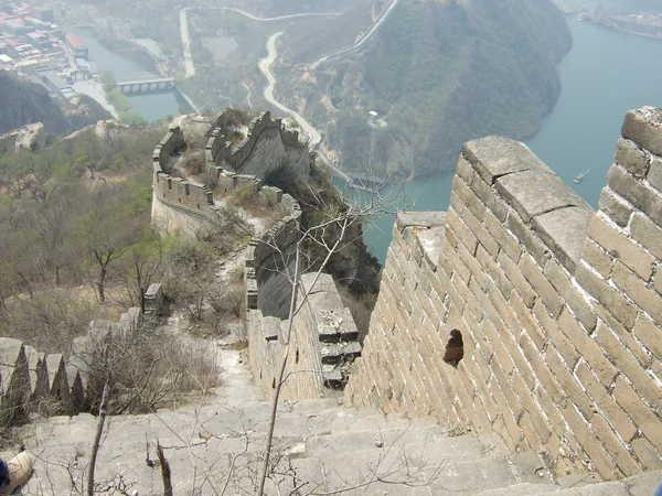 Huanghuacheng wall and towers crossing a steep green ridge Huanghuacheng wall and towers crossing a steep green ridge