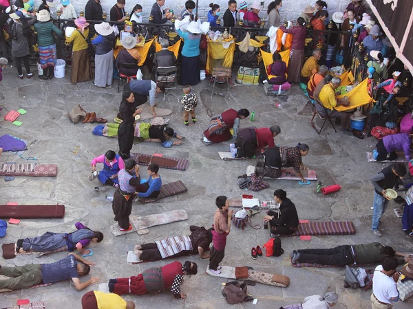 Pilgrims praying respectfully outside Jokhang Temple in Lhasa