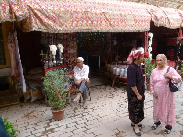 Residents walking through a lane in Kashgar old town, Xinjiang