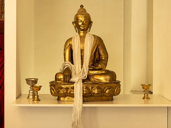 Khata scarves placed near Buddhist figures and butter lamps Khata scarves placed near Buddhist figures and butter lamps