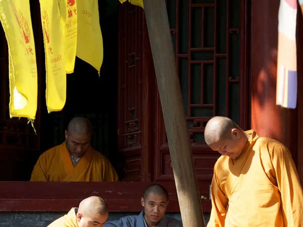 Shaolin monks gathered outside a monastery building
