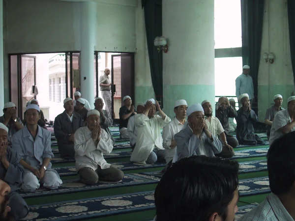 Worshippers seated inside West Cross Mosque in Lanzhou, Gansu Worshippers seated inside West Cross Mosque in Lanzhou, Gansu