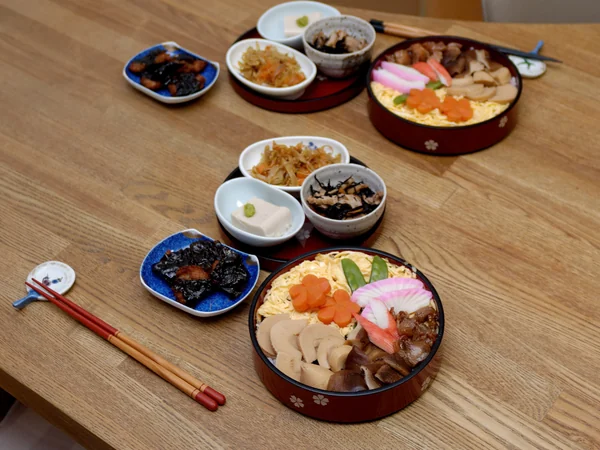 Chopsticks resting beside an individual bowl at a Chinese table setting Chopsticks resting beside an individual bowl at a Chinese table setting