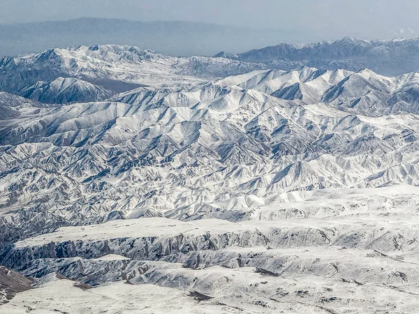 Snow-capped Qilian Mountains above grassland in northwestern China