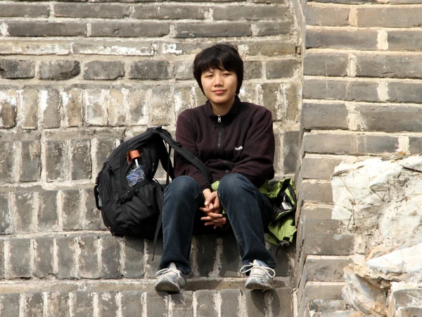 Visitor climbing stone steps on the Great Wall at Mutianyu near Beijing