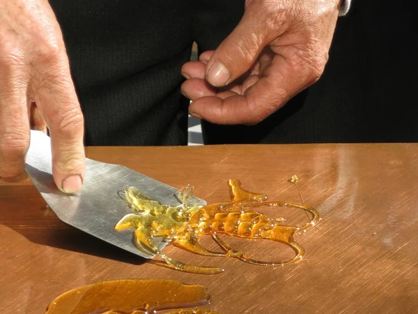 Traditional sugar painting made at a festival market
