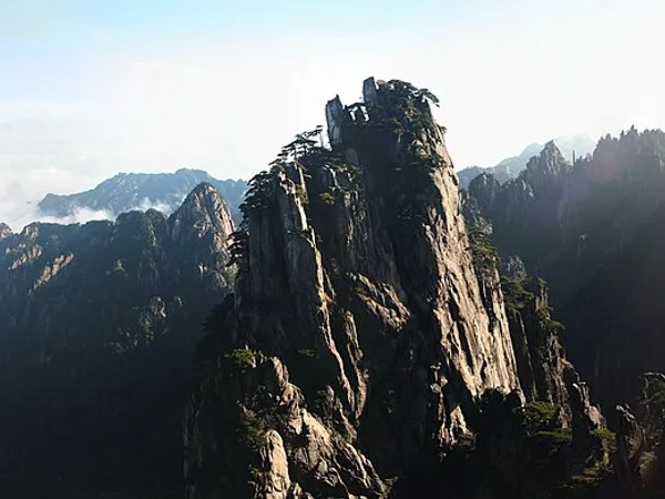 Granite peaks and pine forest at Huangshan during the autumn shoulder season Granite peaks and pine forest at Huangshan during the autumn shoulder season