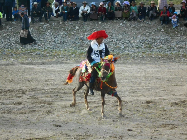 Horse rider taking part in an Ongkor summer festival in Tibet Horse rider taking part in an Ongkor summer festival in Tibet