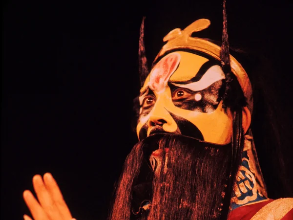 Jing role wearing patterned painted-face makeup in Peking opera