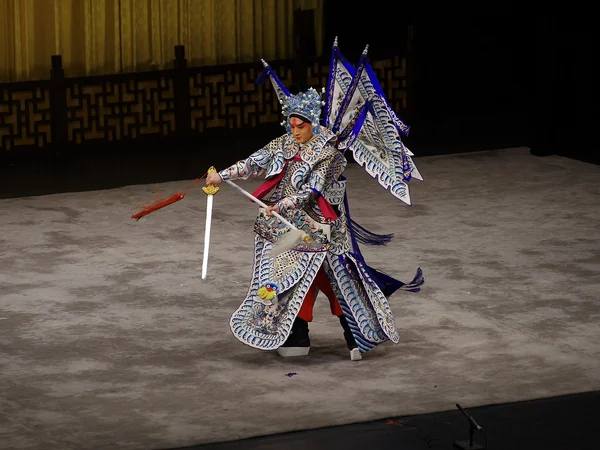 Peking opera performers singing and acting on a traditional stage Peking opera performers singing and acting on a traditional stage
