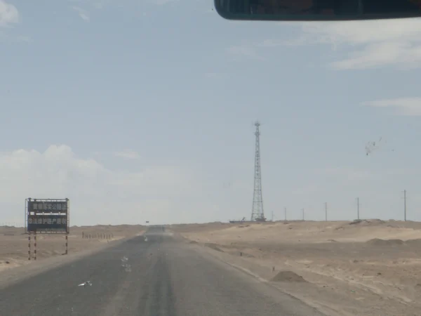 Highway through arid plateau terrain in Qinghai